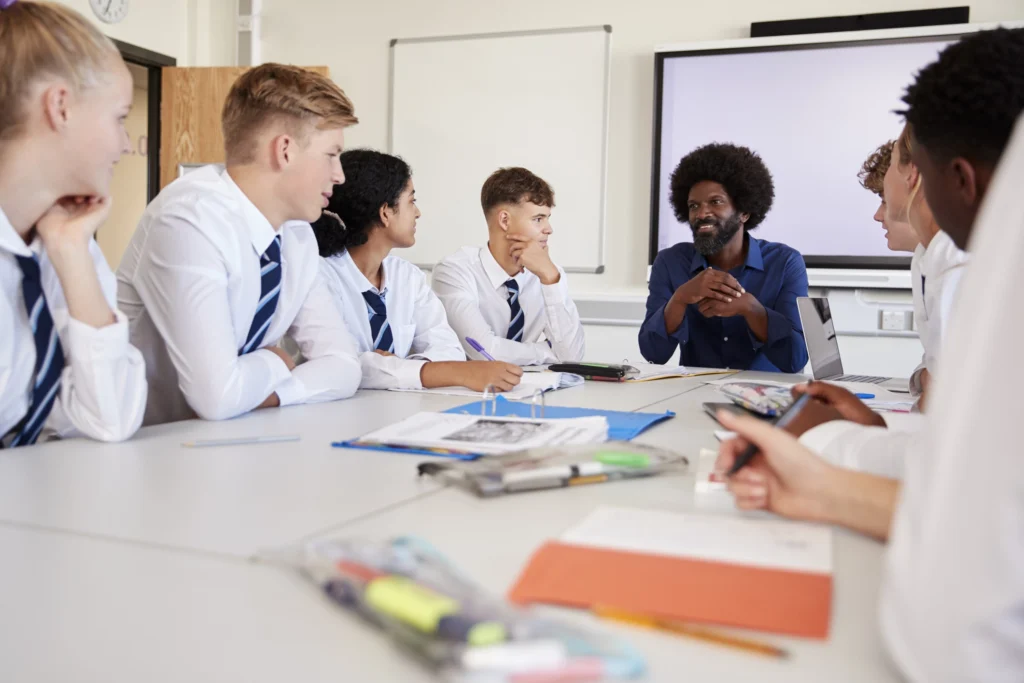 Male Postgraduate teacher teaching class during apprenticeship